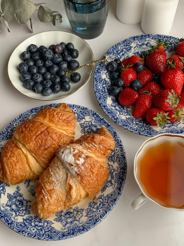 Plates with croissants and berries
